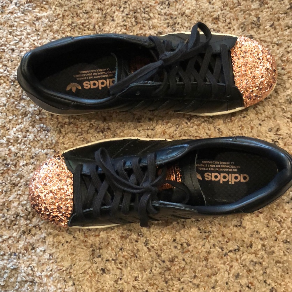 Adidas women’s superstar studded metal toe.